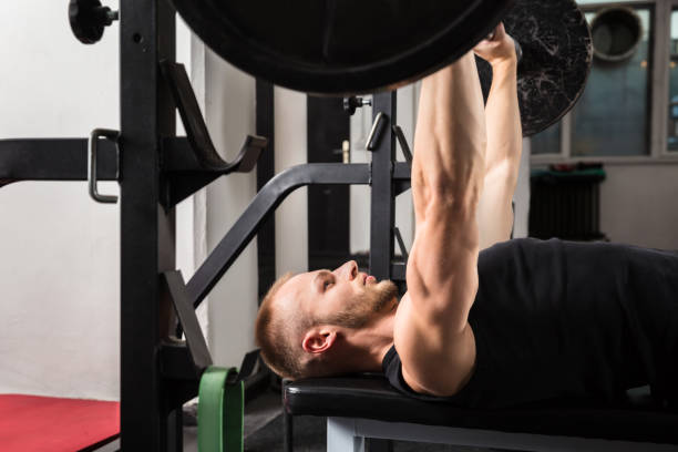 istock Man Working Out With Barbell 915447306