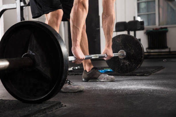 istock Fitness Man With Weights Doing Exercises 915447308