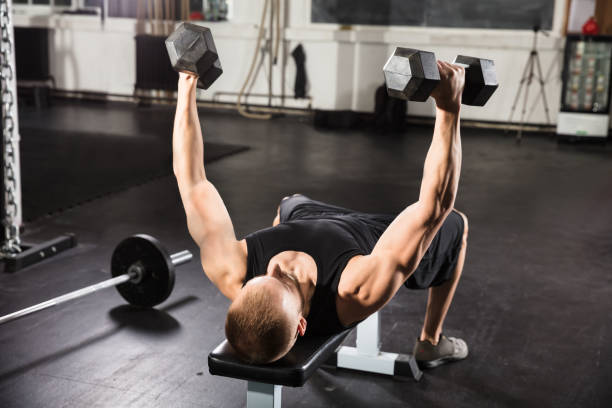 istock Young Man Working Out In Gym 915447358