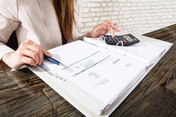 istock Businesswoman Calculating Invoice 915448358