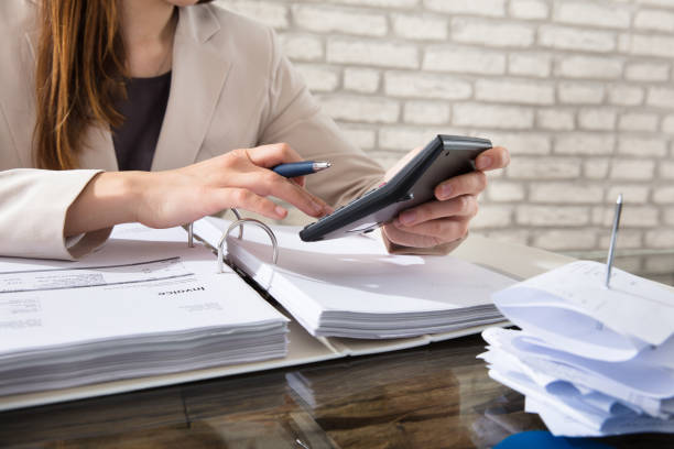 istock Businesswoman Calculating Invoice 915448366