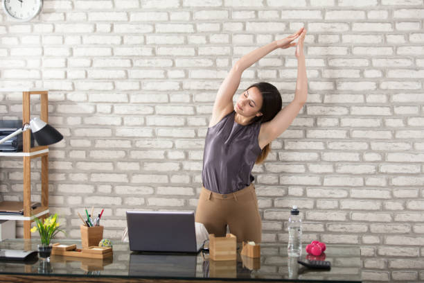 businesswoman stretching - yoga business women indoors imagens e fotografias de stock