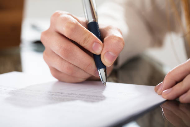 istock Business Person Signing Document With Pen 915451224