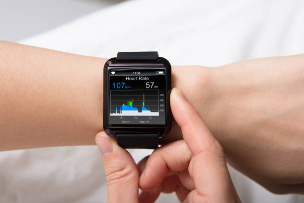 Heart Beat Monitor On Smart Watch Smart Watch Showing Heartbeat Monitor On Woman's Hand smart watch stock pictures, royalty-free photos & images