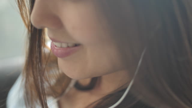 Close-up Asian woman listening to music
