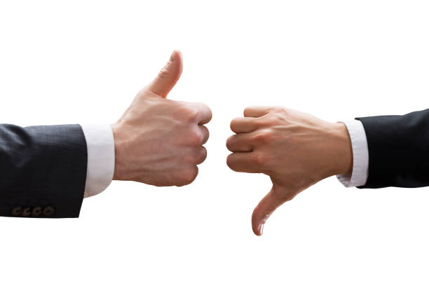 istock Two Businesspeople Hands Showing Thumb Up And Thumb Down Sign 915454872