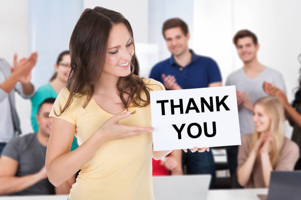 istock Smiling Woman Holding Placard 915455328
