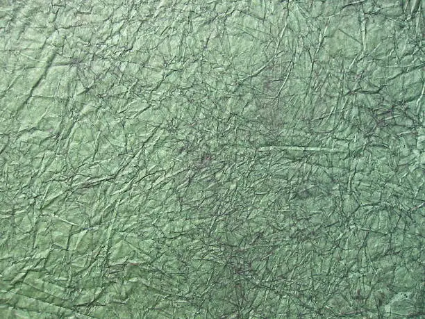 Dark-green crushed paper for background usage