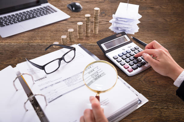 Businessperson Analyzing Bill With Magnifying Glass Close-up Of A Businessperson's Hand Analyzing Bill With Magnifying Glass At Workplace bowie seamount stock pictures, royalty-free photos & images