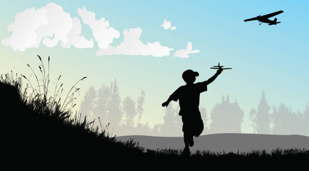 A Childs Dream Of Flight Boy playing with a toy airplane in an open field while a real airplane is flying in the sky pics for free and stock illustrations