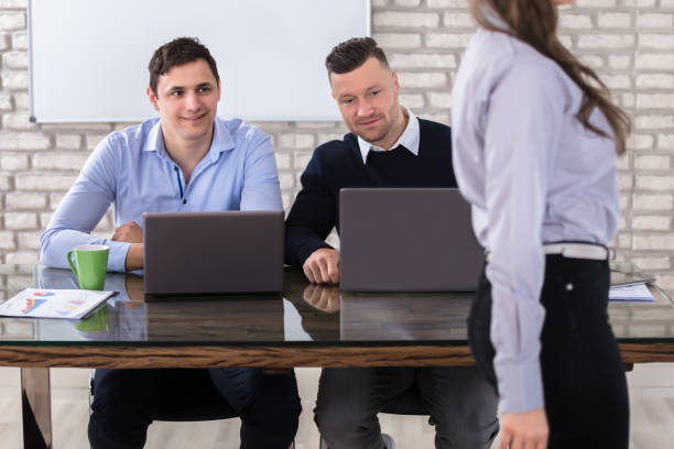 istock Businessmen Looking At Woman 915457952