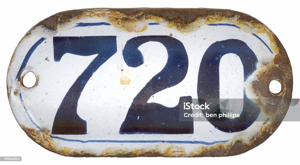 Number 720 An antique rusted house number plaque isolated on white. Ancient Stock Photo