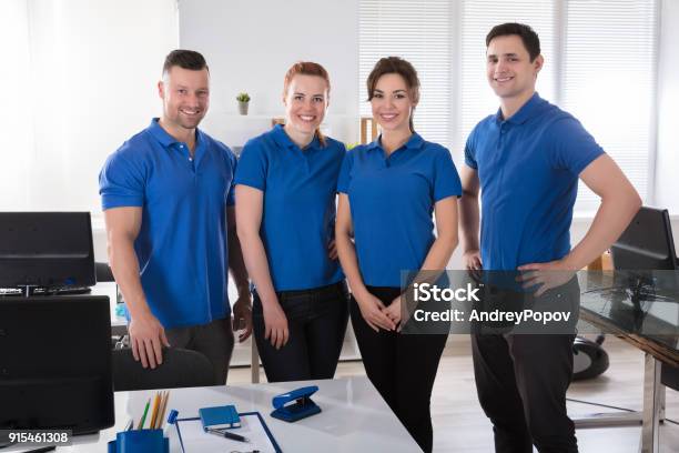 Portrait Of A Janitors In The Office Stock Photo - Download Image Now - Uniform, Teamwork, Cleaning