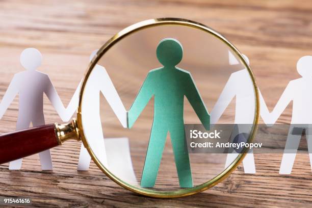 Magnifying Glass On Cutout Figures Stock Photo - Download Image Now - Recruitment, Magnifying Glass, Customer