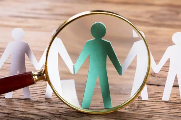 Photo of Magnifying Glass On Cut-out Figures