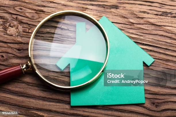 Magnifying Glass And Green Paper House Stock Photo - Download Image Now - Examining, House, Tax