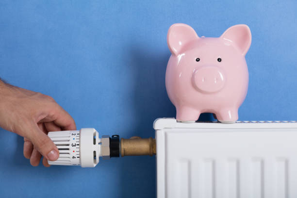 istock Man's Hand Adjusting Thermostat 915461730