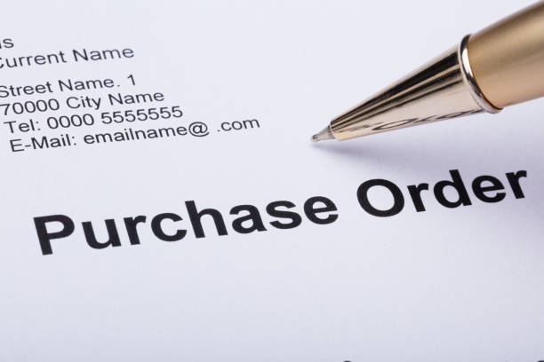 istock Person Hand Filling A Purchase Order Form 915462530