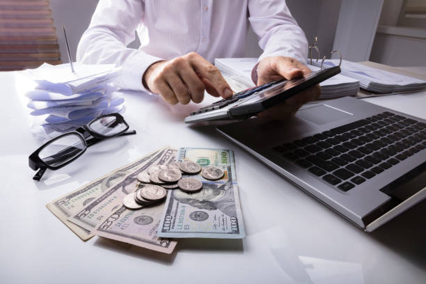 istock Businessman Using Calculator With Dollar Currency 915462716