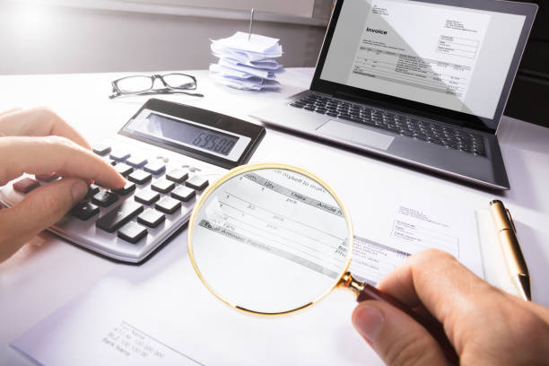 businessperson analyzing bill with magnifying glass - tax tax form refund financial advisor imagens e fotografias de stock
