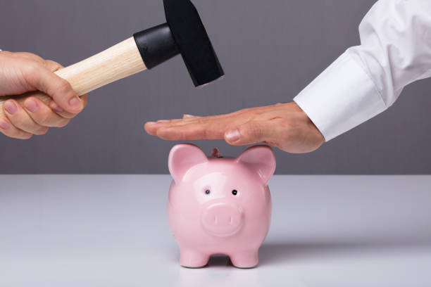 istock Businessman's Hand Saving Piggybank 915465580