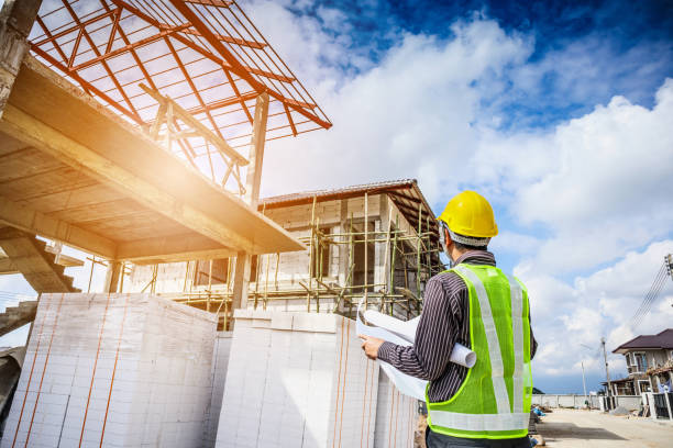 istock Asian business man construction engineer worker at house building site 915482992