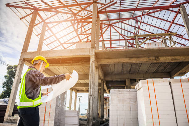 istock Asian business man construction engineer worker at house building site 915482994
