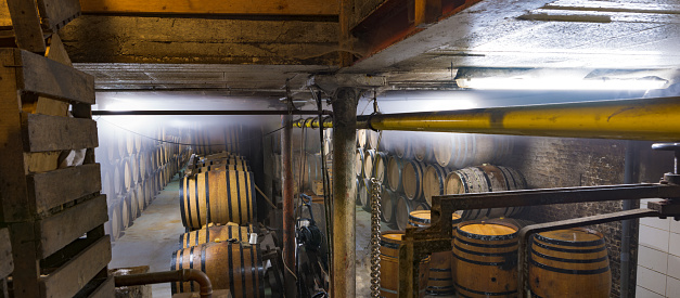 Stack of oak barrels in cellar in old brewery in Brussels, Belgium