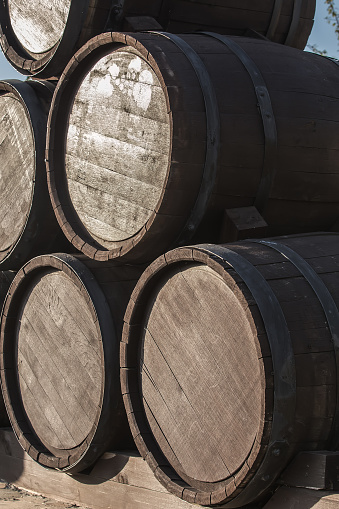 Wooden barrels in a pile on a pallet. Closeup.