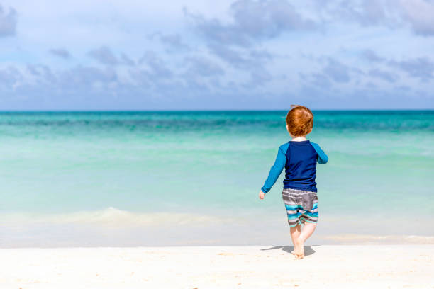 istock Baby Boy Walking on Tropical Beach, Cayo Coco, Cuba 915503220