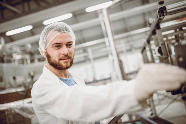 istock Smiling Scientist Controller Doing Revision in Bottling Plant 915503440