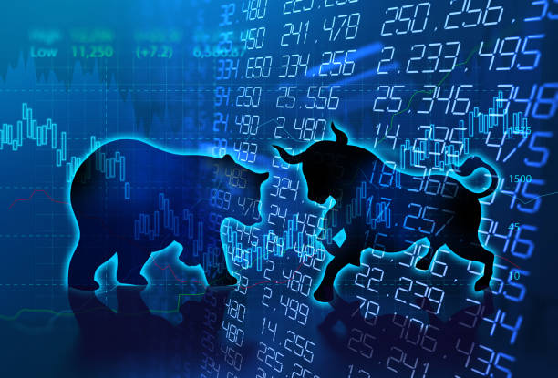 silhouette form of bull and bear on technical financial graph stock photo