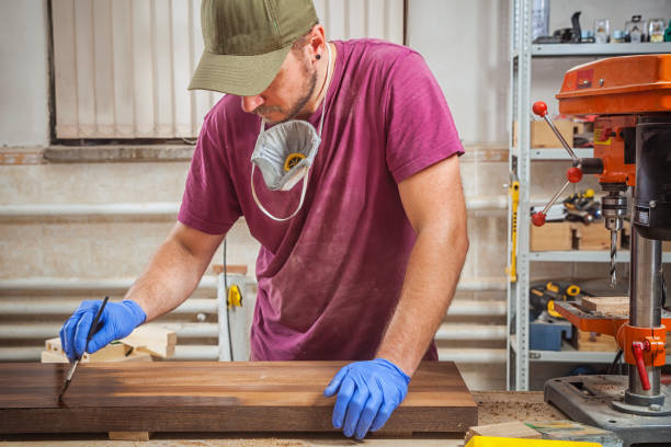 istock man paints a wooden 915528274