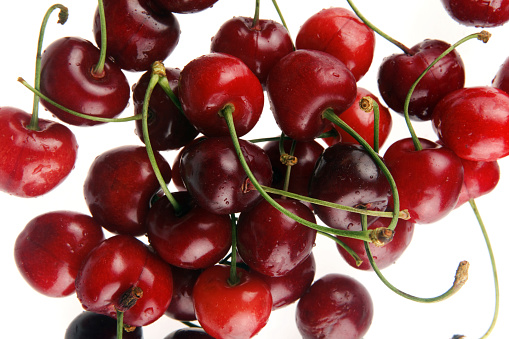 Ripe sweet cherry on a branch. Abundant harvest. Close-up.