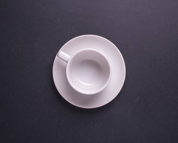 istock White new empty coffee cup or cup for hot drink. Studio shot on black stone table 915530366