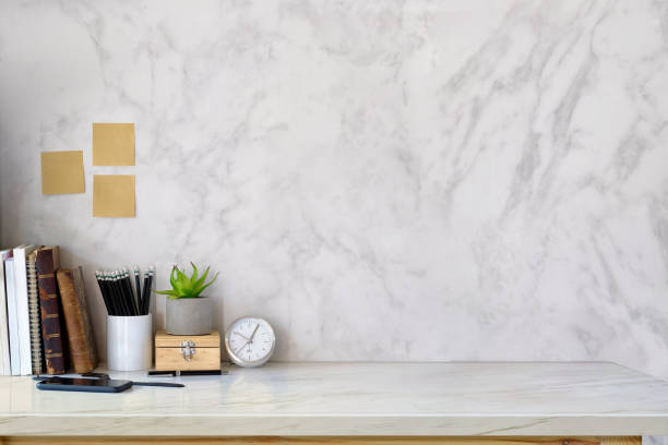 istock Workspace desk books, house plant, pencils and clock with copy space 915533154