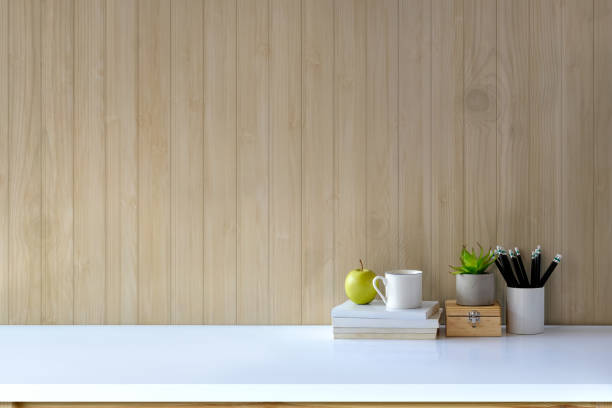istock Workspace desk with books, house plant, pencils and coffee mug with copy space 915533880