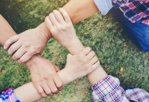 istock Business partners join hands together. Teamwork and unity are one and the same. 915534188