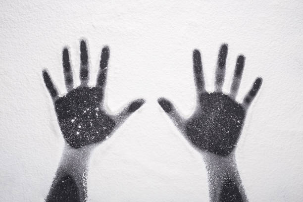 istock Top view hand prints in flour or white powder on black table 915534856