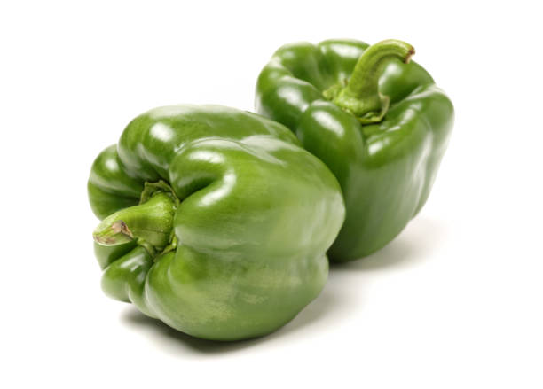 istock Isolated green capsicum couple on white background 915544042