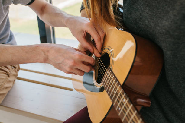 istock Learning to play the guitar. Music education and extracurricular lessons. 915544372