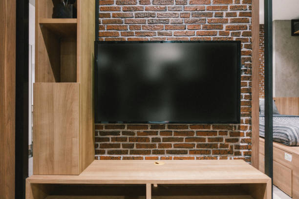 istock TV with blank screen and shelf cabinet at night, interior design 915544528