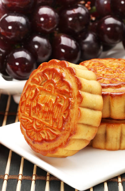 istock Moon cake, fruit persimmon apple orange close up on white background 915547182