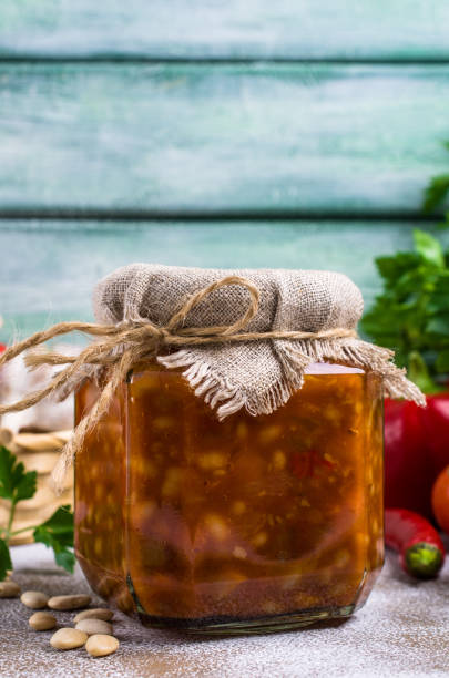 Canned beans with vegetables Canned beans with vegetables in tomato sauce on wooden background. Selective focus. halle north rhine westphalia stock pictures, royalty-free photos & images