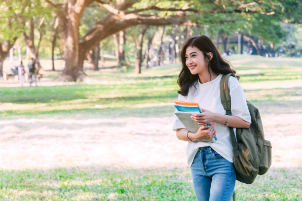 istock Woman students holding notebooks outdoors.Education concept 915547720