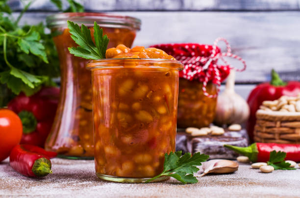 Canned beans with vegetables Canned beans with vegetables in tomato sauce on wooden background. Selective focus. halle north rhine westphalia stock pictures, royalty-free photos & images