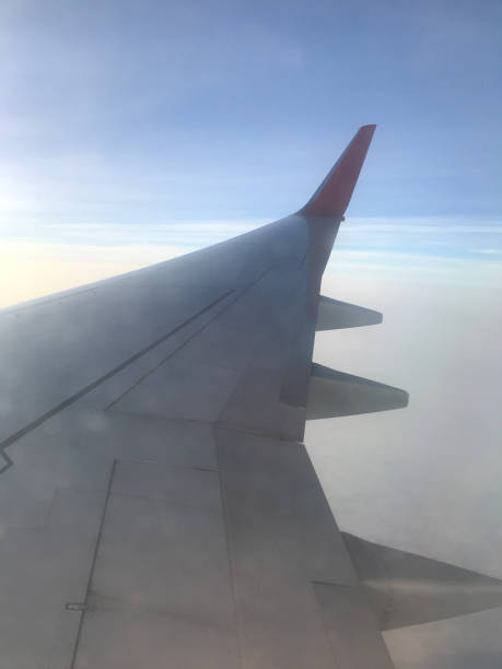 istock Wing of an airplane flying above the clouds. 915556520
