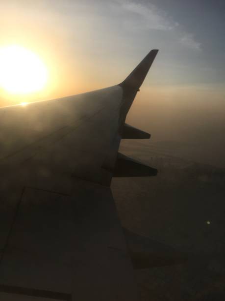 istock Sunset sky view over the wing of the plane. 915556546