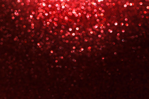red glitter bokeh lights Blurred abstract background for Valentines, birthday, anniversary, wedding, new year and Christmas.