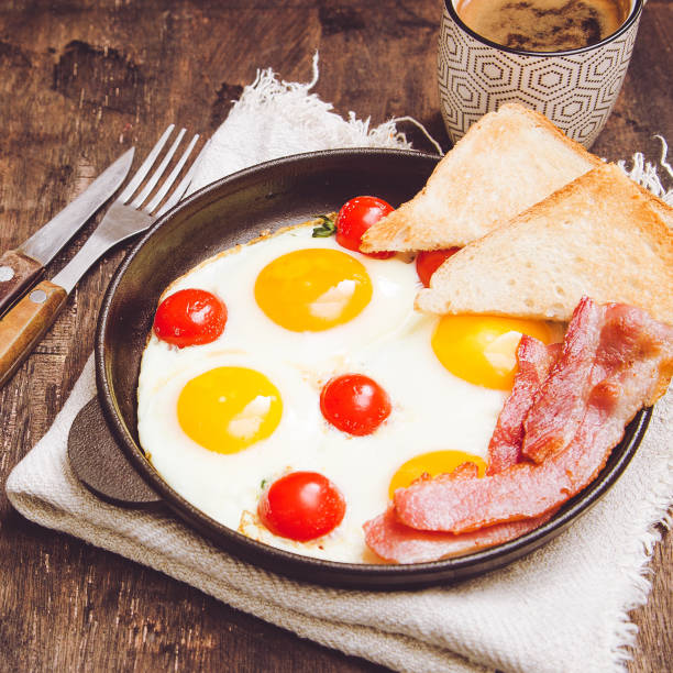 istock breakfast with eggs, cherry tomatoes, bacon and fresh toasted toast 915563860